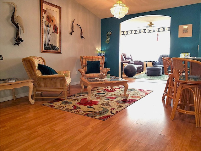 living area with an inviting chandelier and hardwood / wood-style floors