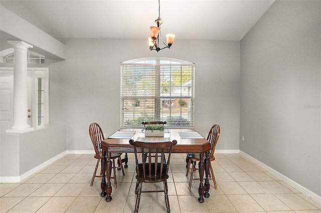 tiled dining space with decorative columns and a chandelier