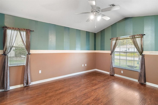 empty room with wood-type flooring, ceiling fan, and lofted ceiling