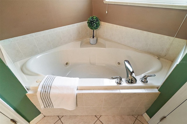 bathroom featuring tiled tub and tile patterned flooring