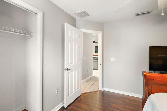 bedroom featuring ceiling fan, hardwood / wood-style flooring, and a closet