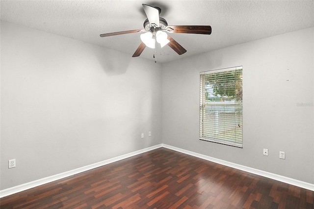 spare room featuring ceiling fan, dark hardwood / wood-style floors, and a textured ceiling