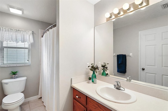 bathroom featuring tile patterned flooring, a textured ceiling, toilet, walk in shower, and vanity