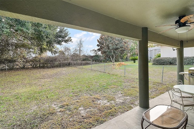 view of yard featuring ceiling fan and a patio area