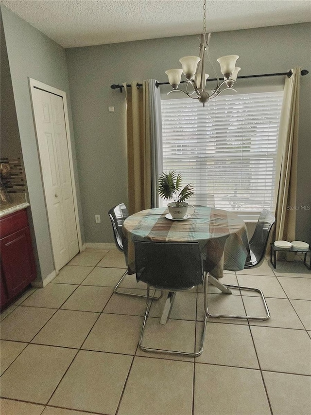 dining room featuring light tile patterned floors, plenty of natural light, and a chandelier