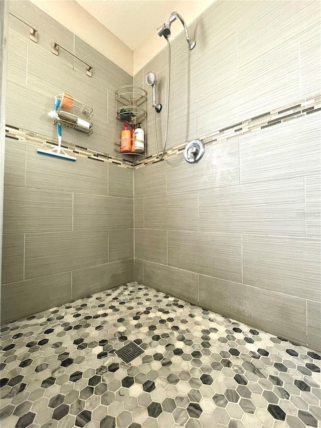 bathroom with tiled shower