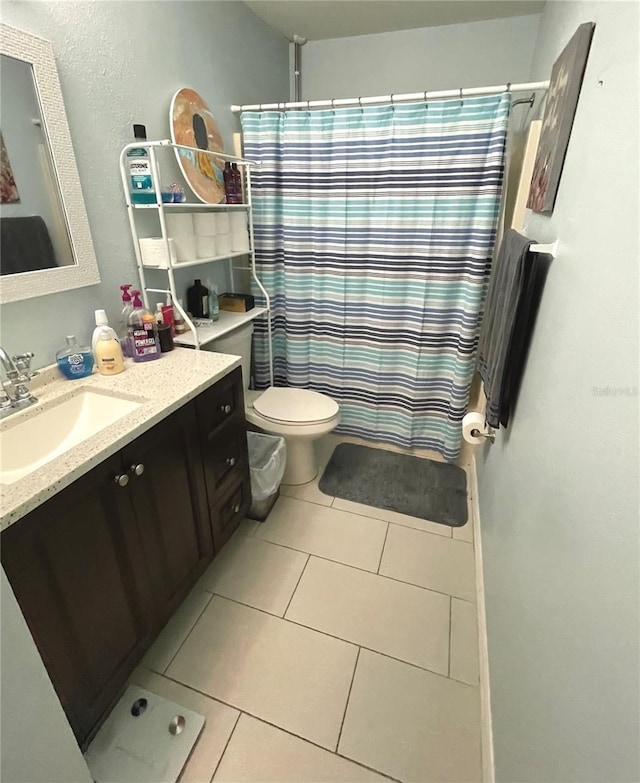 bathroom featuring toilet, tile patterned flooring, and vanity