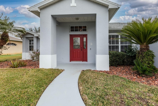 doorway to property with a yard