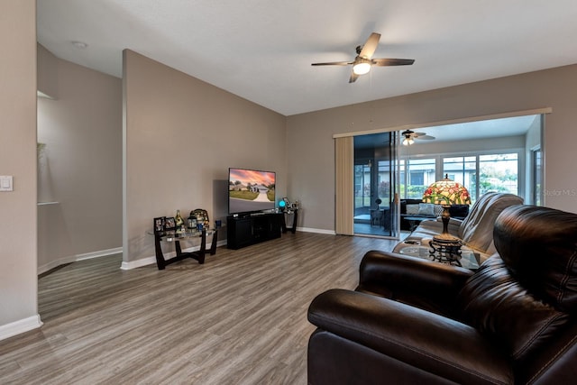 living room with ceiling fan and hardwood / wood-style floors