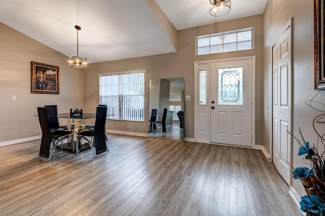 foyer entrance with light wood-type flooring and a chandelier