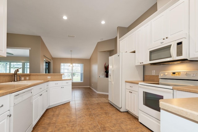 kitchen featuring pendant lighting, white appliances, light tile patterned floors, and white cabinetry