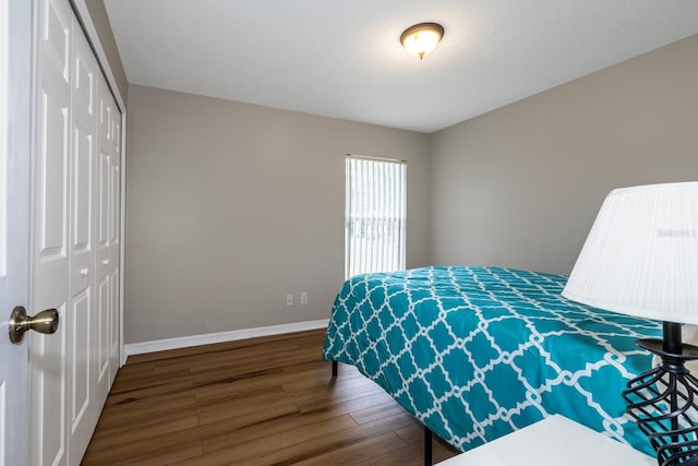 bedroom with hardwood / wood-style flooring and a closet