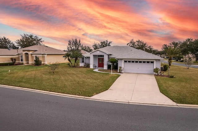 single story home with a garage and a yard