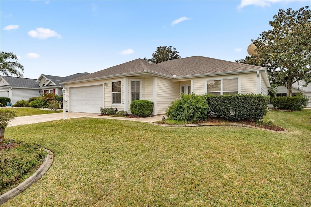 ranch-style home with a garage and a front lawn