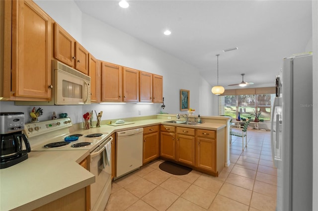 kitchen with a sink, light countertops, ceiling fan, white appliances, and a peninsula