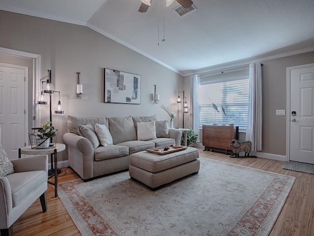 living room with lofted ceiling, ceiling fan, ornamental molding, and light hardwood / wood-style floors