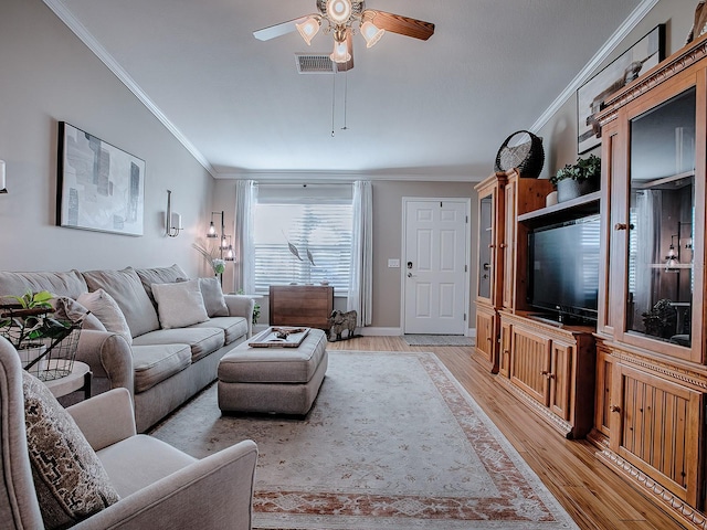 living room with ceiling fan, light wood-type flooring, and crown molding