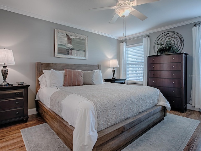 bedroom with light wood-type flooring, ceiling fan, and ornamental molding