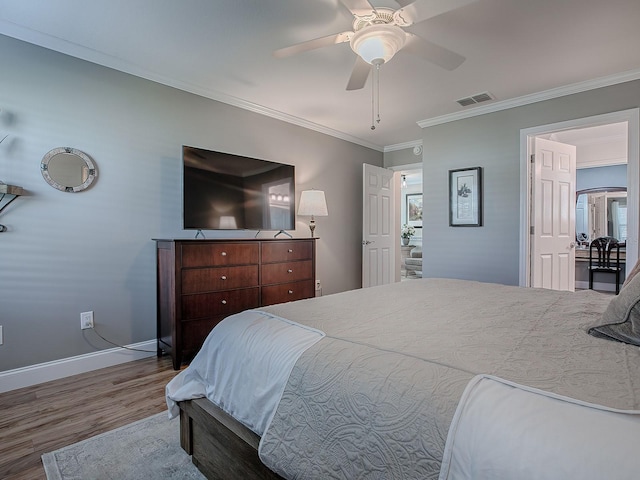 bedroom featuring ceiling fan, hardwood / wood-style flooring, and crown molding