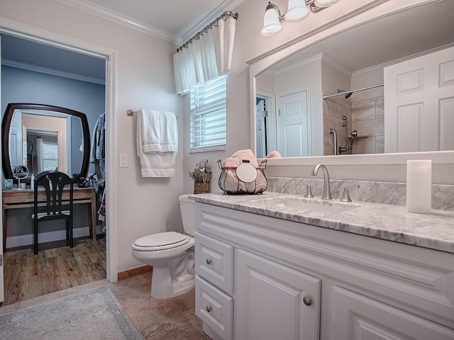 bathroom with toilet, ornamental molding, walk in shower, and vanity