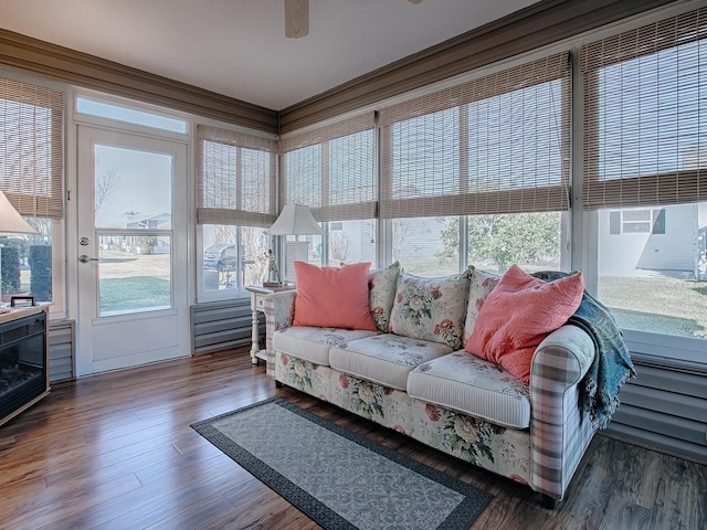 sunroom / solarium featuring ceiling fan and plenty of natural light