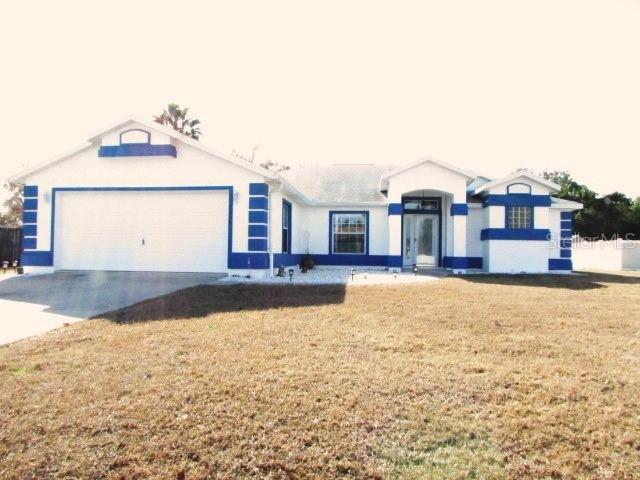 view of front of home featuring a garage and a front lawn