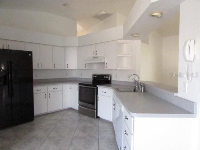 kitchen with electric stove, white cabinetry, black fridge, and sink