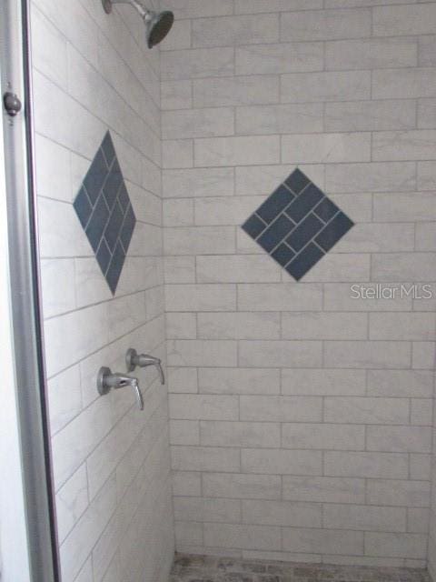 bathroom with tiled shower