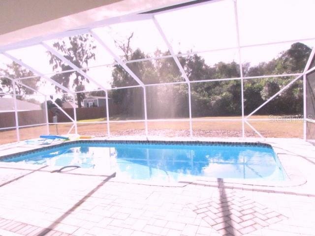 view of pool featuring a lanai and a patio area