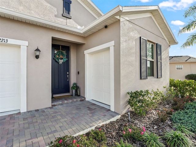 view of exterior entry featuring a garage