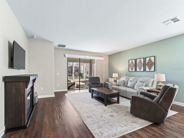 living room with dark hardwood / wood-style flooring