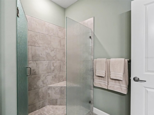 bathroom featuring a shower with shower door