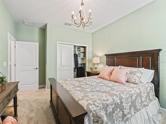 bedroom with a notable chandelier, light colored carpet, and a closet