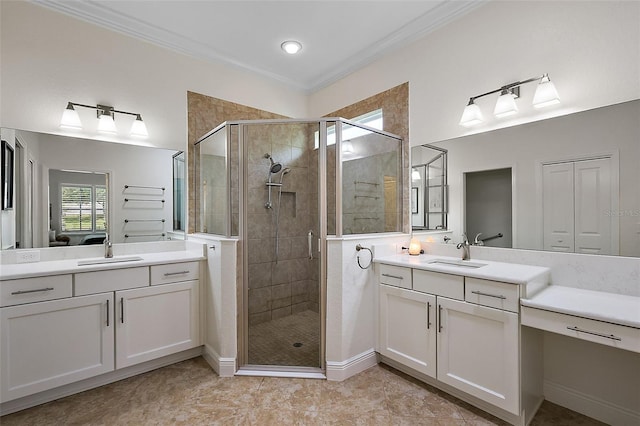 bathroom featuring vanity, a shower with door, and crown molding