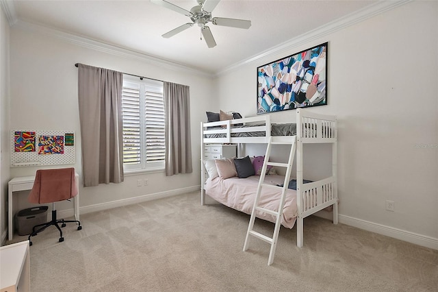 carpeted bedroom featuring ceiling fan and crown molding