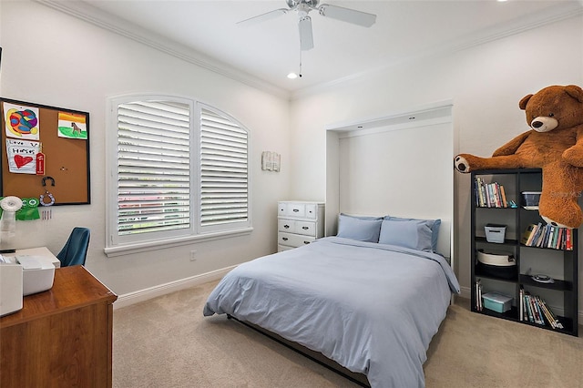 carpeted bedroom featuring ceiling fan and crown molding