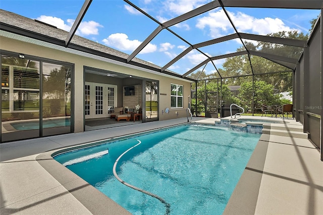 view of pool featuring french doors, glass enclosure, an in ground hot tub, and a patio