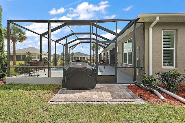 view of patio featuring grilling area and glass enclosure