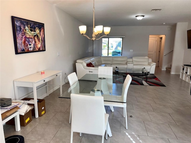 tiled dining space with a notable chandelier