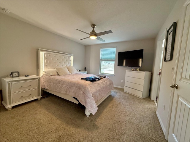 bedroom featuring baseboards, a ceiling fan, and light colored carpet