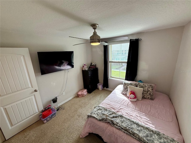 carpeted bedroom with a textured ceiling and ceiling fan