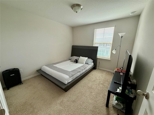 carpeted bedroom featuring baseboards and a textured ceiling