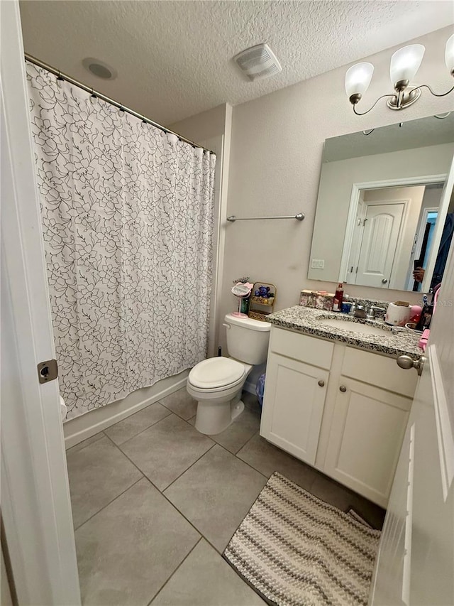 full bathroom featuring toilet, a textured ceiling, vanity, shower / bath combination with curtain, and tile patterned flooring