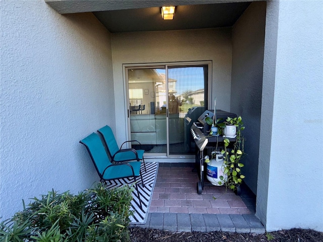 doorway to property featuring stucco siding