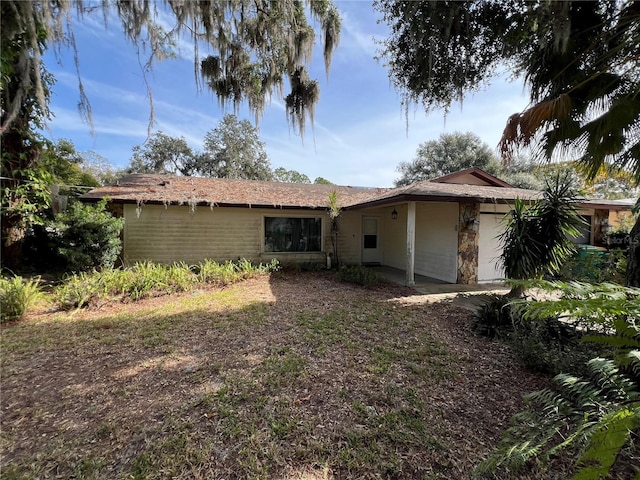 rear view of house featuring a garage