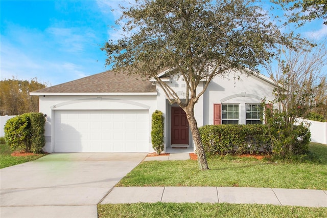 view of front of house with a garage and a front lawn