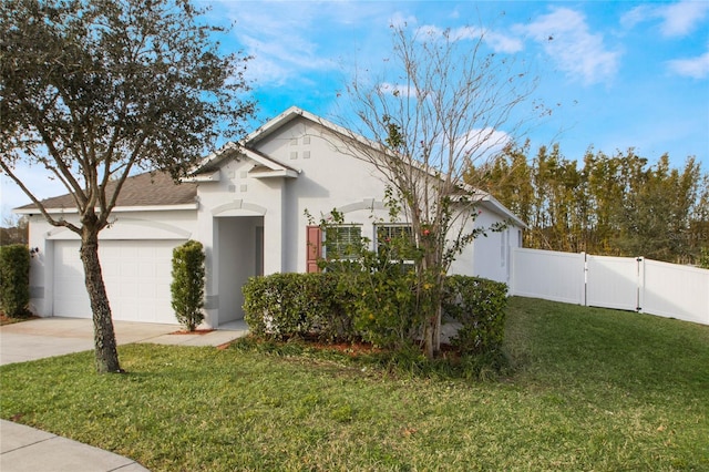 single story home featuring a garage and a front lawn