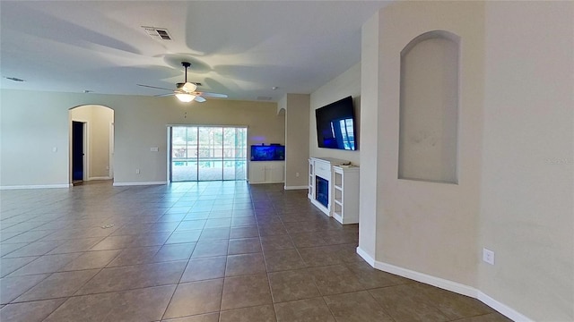 unfurnished living room featuring ceiling fan and tile patterned floors