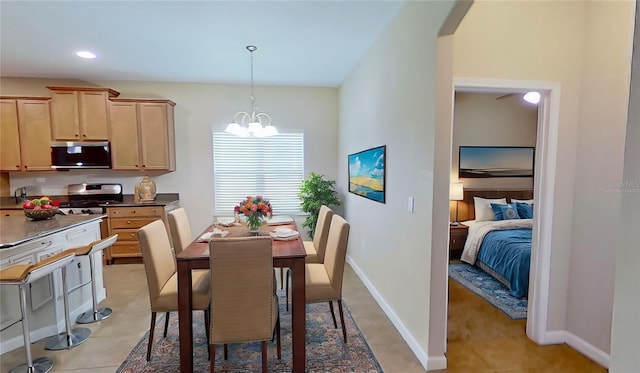 tiled dining area featuring a chandelier