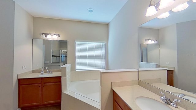 bathroom with separate shower and tub, a notable chandelier, and vanity